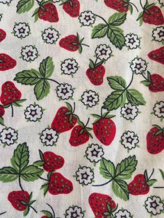 the fabric has strawberries and flowers on it