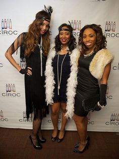 three women standing next to each other in front of a white wall with the words ciroc on it