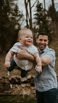 a man holding a baby in his arms