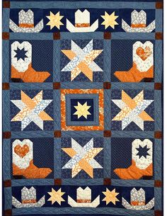 a blue quilt with orange and white stars in the center, on top of it