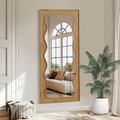 a living room with a large mirror on the wall and a potted plant next to it