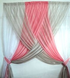 an image of curtains with pink and grey colors on them, hanging in front of a white wall