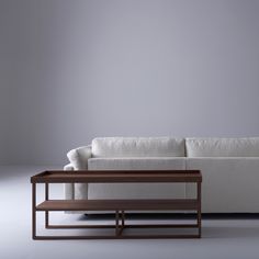 a white couch sitting next to a wooden table