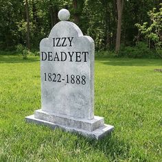 a headstone sits in the middle of a grassy area with trees behind it and an inscription that reads izzy dead yet