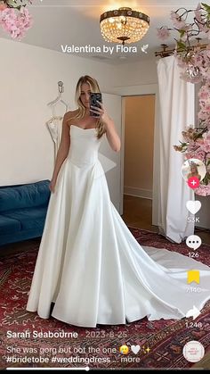 the woman is taking a selfie in her wedding dress