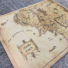 a wooden map with the middle earth on it