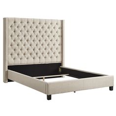 an upholstered bed frame with buttons on the headboard