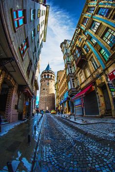 an image of a street that looks like it is going through the city with buildings on both sides