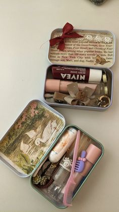 three tins with different types of items in them on a table next to each other