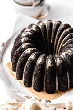 a chocolate bundt cake with icing on a plate