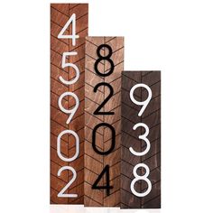 three wooden signs with numbers on them