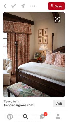 a large bed in a bedroom next to a window with curtains on the windowsill