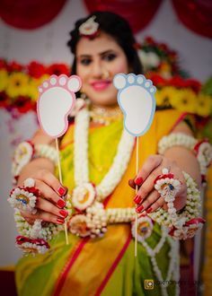 a woman holding up two hand prints on sticks