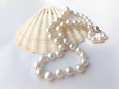 NB: THIS ITEM DOES NOT SHIP TO GERMANY Listing: Awesome 48cm silver white South Sea real pearl strand. #70  Color:  Silver white Length: 48cm (19 inches) Shape:  Near round Size: 8mm - 10mm width Enhancement: Nil Clasp: Fancy 925 silver ball clasp Pearl info:  Cultured. Natural color. Luster: Good Nacre:  Good Body:  Good with few natural organic spots. Packaging:   PLEASE NOTE. Read POLICIES and SHIPPING INFORMATION. White Round Pearl Necklace With Pearl Charm, White Akoya Pearl Necklace With Sterling Silver Clasp, White Pearl Drop Round Necklace, White Round Pearl Drop Necklace, White Akoya Pearl Single Strand Necklace, Classic White Single Strand Pearl Necklace, White Single Strand Pearl Necklace With Round Beads, Classic White Pearl Necklace With Round Beads, Classic White Pearl Drop Necklace