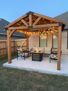 a covered patio with furniture and string lights