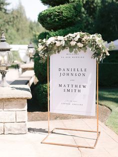 a welcome sign sitting on top of a sidewalk