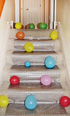 an image of balloons on the stairs with caption that reads, big blow up egg hunt squeeze small treats into balloons then flow them to see what's inside