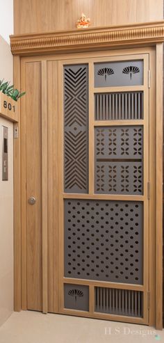 a wooden door with decorative designs on the front and side panels in an entry way