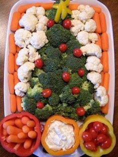 a christmas tree made out of veggies on a platter with peppers, carrots and broccoli