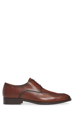 A tapered moc toe elongates the frame on this formal-ready derby set on a half-rubber sole for traction and versatility. 1 1/4" heel (size 11) Lace-up style Injected memory foam insole Arch support Leather upper and lining/leather and rubber sole Made in Spain Goodyear Welted Snip Toe Oxfords For Business Casual, Elegant Cognac Oxfords With Goodyear Welt Construction, Brown Snip Toe Dress Shoes For Semi-formal Occasions, Business Cognac Oxfords With Goodyear Welt, Cognac Leather Cap Toe Shoes For Derby, Elegant Brown Derby Shoes With Rubber Sole, Semi-formal Cognac Oxfords With Leather Sole, Formal Oxfords With Goodyear Welting And Snip Toe, Classic Snip Toe Oxfords For Office