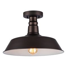 an industrial style light fixture with a black finish and white glass shade on the top