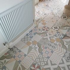 a bathroom with a radiator and tiled floor