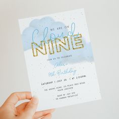 someone holding up a card with the words we are on cloud nine in gold glitter