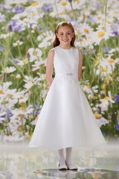 Gorgeous Communion dress with high neckline and beaded waist detailing. Call our store for additional availability and sizing options. 631-419-2698 120339 JoanCalabres High Neckline Dress, Modest Bride, Tea Length Skirt, White Ball Gowns, Cute White Dress, Satin Belt, Girls White Dress, Purple Bridesmaid Dresses, First Communion Dresses