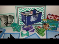 a baby in a crib surrounded by diapers and other items on the table