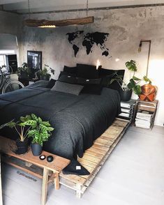 a bed room with a neatly made bed and lots of plants on the side table