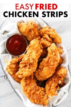 fried chicken strips in a basket with ketchup on the side and text overlay that reads easy fried chicken strips