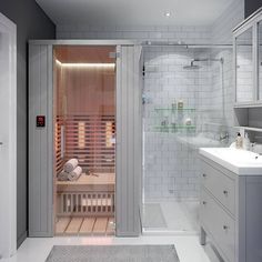 a bathroom with a shower, sink and bathtub