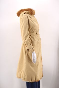 COURREGES 1970s Adorable and chic cotton canvas khaki winter trench coat. Too perfect with rabbit fur trim and a hood. Quilted lining. Gathered puff shoulders and deep front patch pockets. Buttons up the front and button sash belt. Excellent condition. Made in France Marked size 0 ( Courreges sizing ) Measures : bust=.44 Hips= 48 sleeve= 22 length= 40 shoulder= 18 ALL SALES FINAL Trench Coat Vintage, Winter Trench, Winter Trench Coat, Coat Vintage, Sash Belts, Sash Belt, Rabbit Fur, Jacket Coat, Vintage 1970s