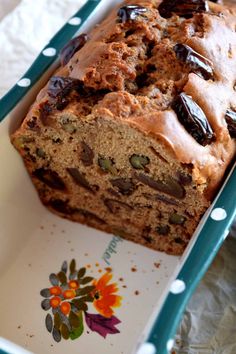 a loaf of bread with raisins and chocolate on it in a blue tray