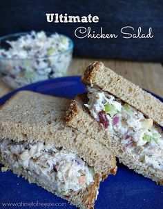 chicken salad sandwich cut in half on a blue plate