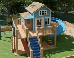 a small blue house with a slide in the back yard