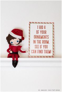 a christmas elf doll sitting on top of a shelf next to a sign that says, i had 4 of your ornaments in the room see if you can find them