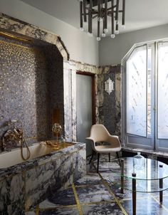 an elegant bathroom with marble walls and flooring