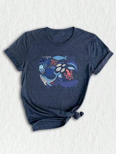 Dive into the vibrant world of ocean-inspired fashion with our retro sea life tee, a perfect blend of nostalgia and contemporary style. This shirt features a stunning array of marine life, including majestic orcas, playful dolphins, and fierce sharks, all beautifully illustrated to capture the essence of the ocean. Made from soft, breathable fabric, it ensures comfort whether you're lounging at home, hitting the beach, or enjoying a casual day out. The 90s-inspired design adds a touch of vintage Retro Ocean, Dolphin Shirt, Ocean Whale, Ocean Shirt, Ocean Nature, Whale Shirt, Shark Shirt, Nature Shirts, 90s Shirts