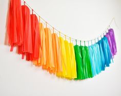 colorful streamers hanging from a string against a white wall