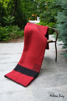 a red and black towel sitting on top of a chair