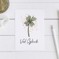 a card with a clover on it and the words viel gluck written in black