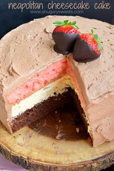 a chocolate and strawberry cheesecake with a slice cut out on a wooden platter