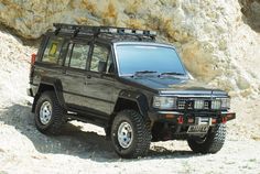 a black jeep parked on the side of a mountain