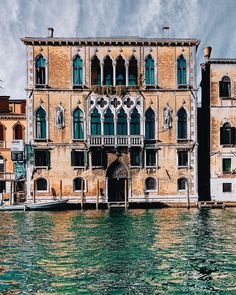 an old building sitting on top of a body of water