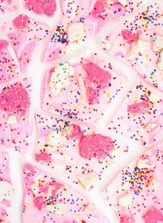 pink and white cake with sprinkles on it