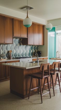 a kitchen with wooden cabinets and stools next to an island in front of a window