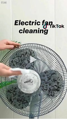 a person is using a fan to clean the bathroom