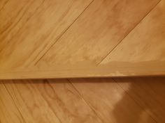 a wooden shelf sitting on top of a hard wood floor