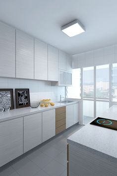 a modern kitchen with white cabinets and counter tops, along with an oven in the center